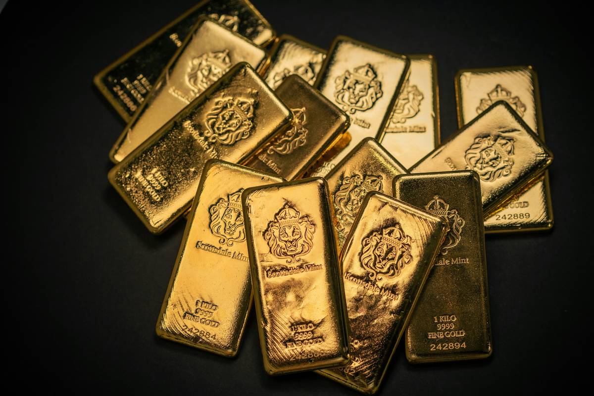 Precious metal scrap recycling process showing gold items being tested and refined