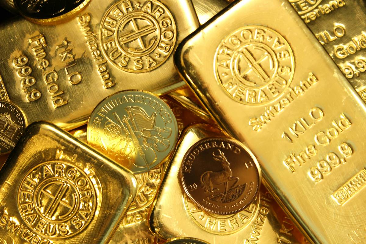 selling scrap gold how to invest: close-up of mixed gold jewelry pieces on a scale